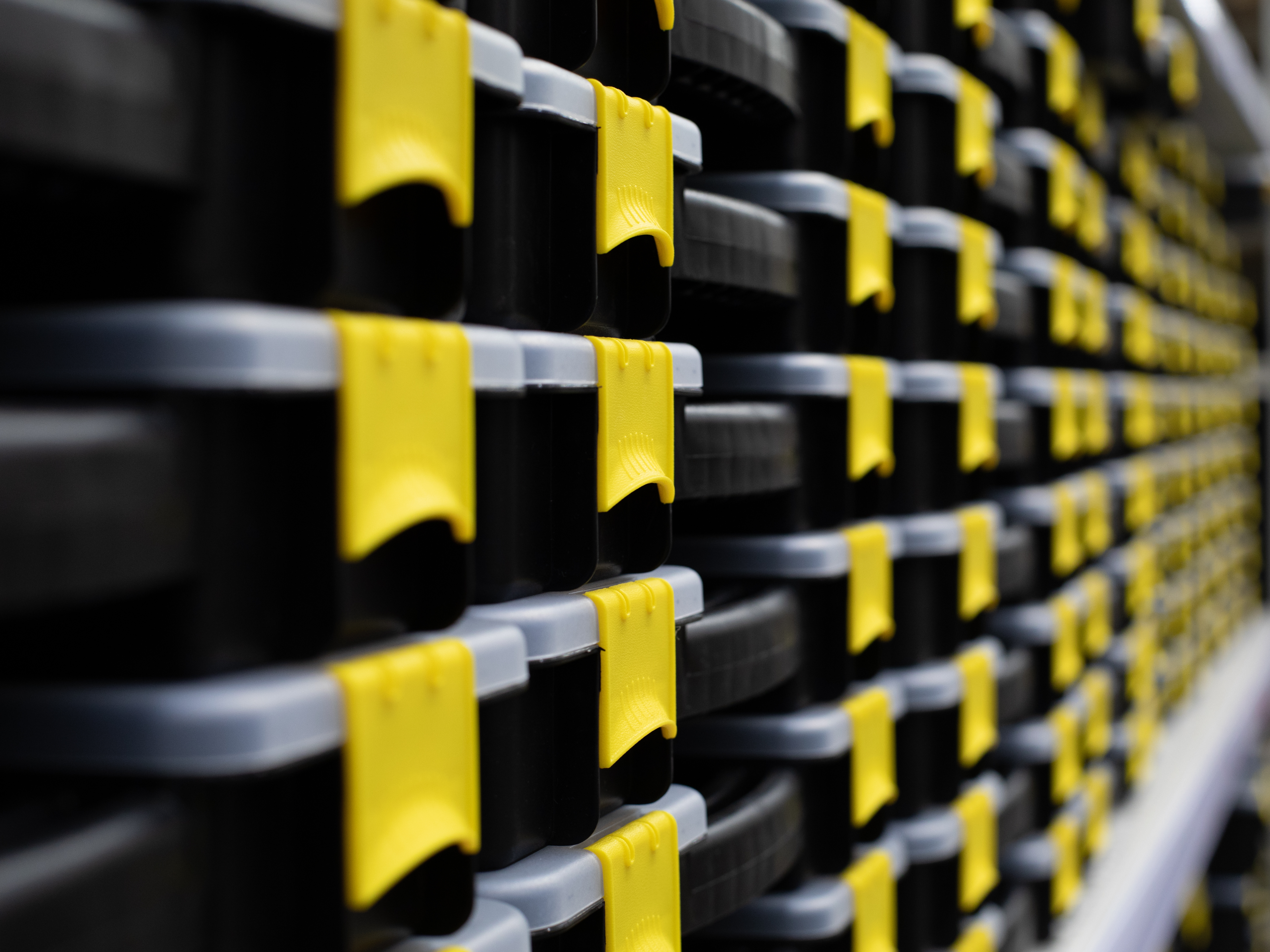 Organized storage bins on a shelf with labeled containers
